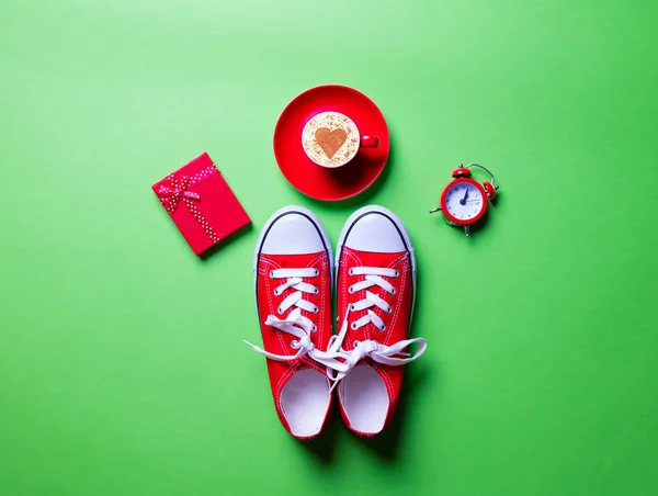 Cup, clock, gift and gumshoes — Stock Photo, Image