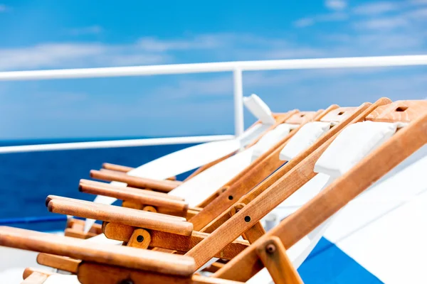 Wooden loungers on blue sky background — Stock Photo, Image