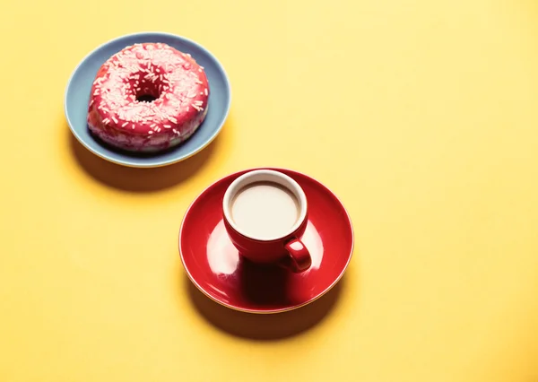 Donut vidrado no prato e xícara de café — Fotografia de Stock