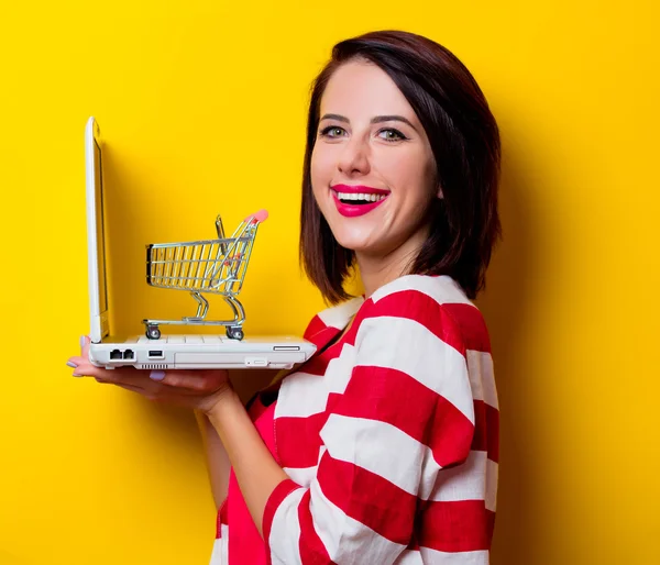 Ung kvinna med vagn och laptop — Stockfoto