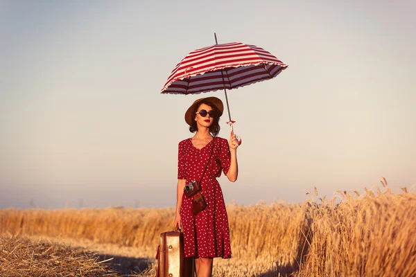 Young woman with suitcase, umbrella and camera — Stock Photo, Image