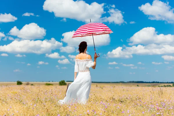 Young woman with suitcase and umbrella — Stock Photo, Image