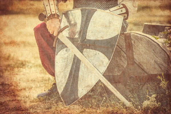 Photo of the brave warrior holding his sword and shield