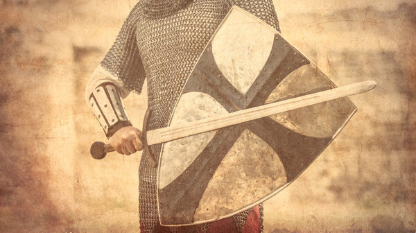 Photo of the brave warrior holding his sword and shield