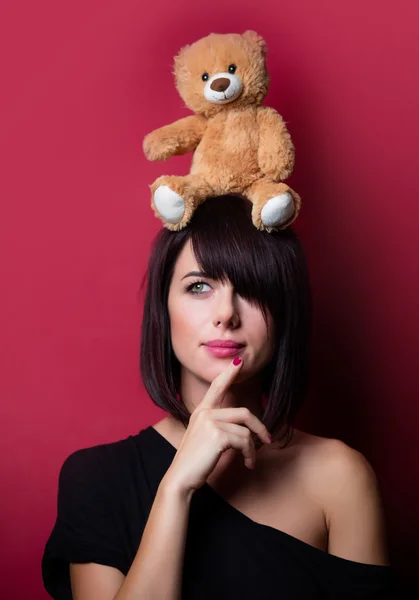 Young woman with teddy bear — Stock Photo, Image