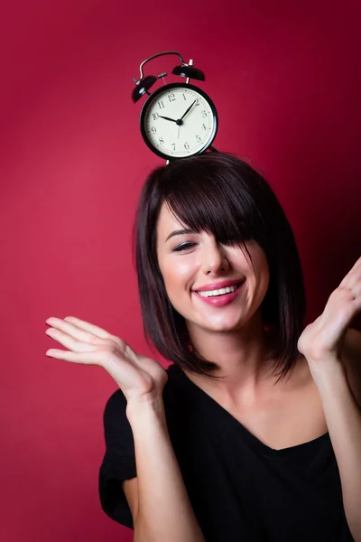 Young woman with alarm clock — Stock Photo, Image