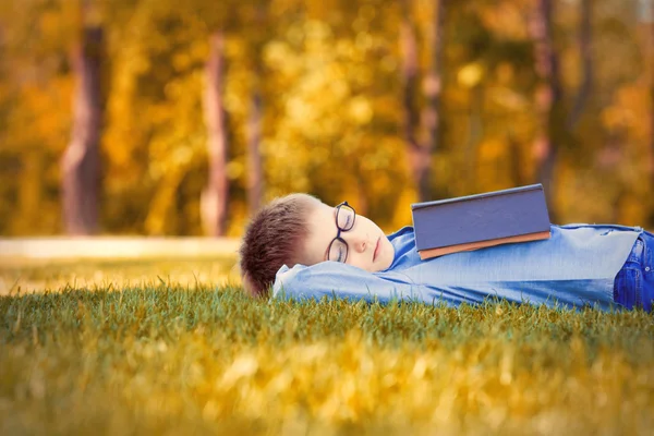 Boy in glasses with a book — Stock Photo, Image