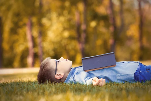 Boy in glasses with a book — Stock Photo, Image