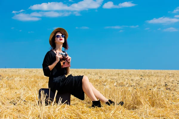 Young woman with suitcase and camera — Stock Photo, Image