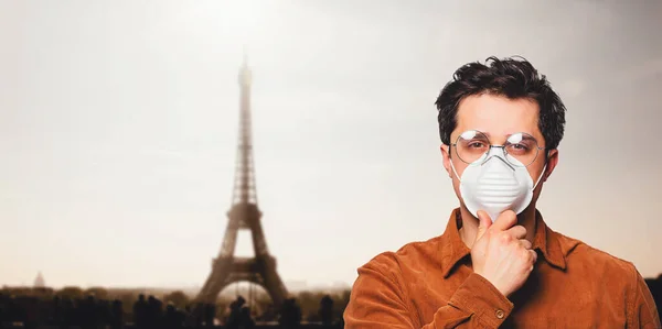 Man in face mask with on street of Paris, France during a Pandemic