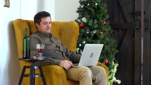 Uomo Beve Vino Lavora Con Computer Nel Periodo Natalizio — Video Stock