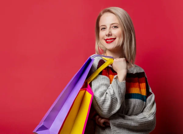 Beautiful Blonde Sweater Shopping Bags Red Background — Stock Photo, Image