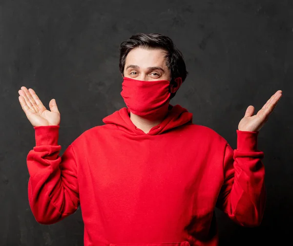 Surprsied Guy Red Sweatshirt Face Mask Dark Background — Stock Photo, Image