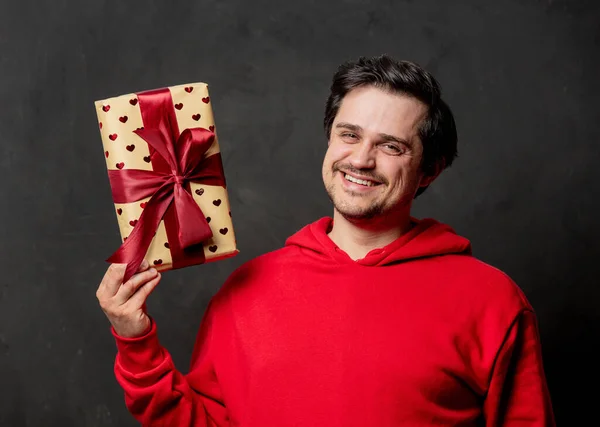 White Guy Red Sweatshirt Hold Gift Box Dark Background — Stock Photo, Image