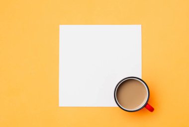 Beyaz model pano ve sarı arka planda bir fincan kahve. 