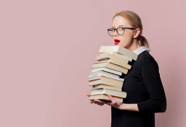 Donna Bionda Abito Nero Con Libri Sfondo Rosa — Foto Stock