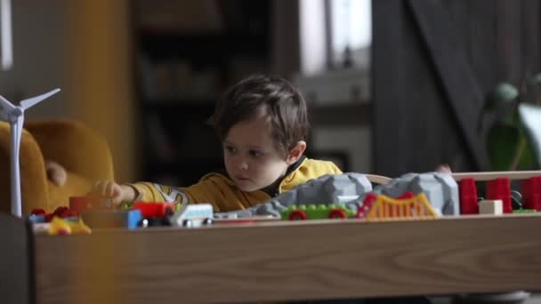 Niño Jugando Con Trenes Sobre Mesa Casa — Vídeo de stock