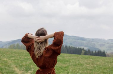 Woman with open hands in a vacation in mountains, Poland. Spring time