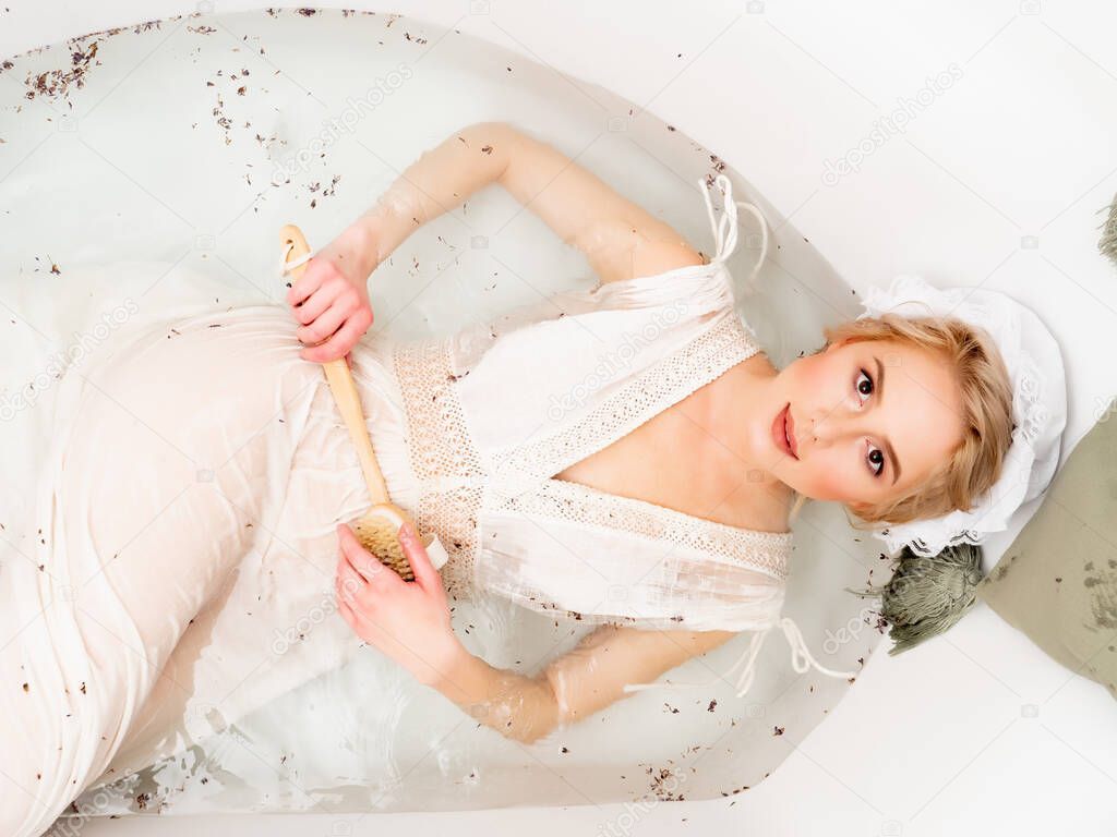 Woman in vintage clothes take a bath with lavender as in the days of the Renaissance