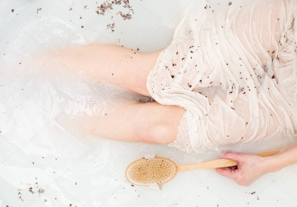 Woman in vintage clothes take a bath with lavender as in the days of the Renaissance