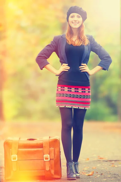 Fille rousse avec valise à l'automne en plein air . — Photo