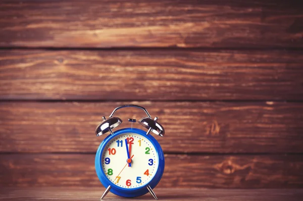 Retro alarm clock on wooden background — Stock Photo, Image