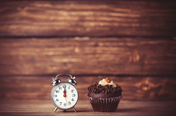 Väckarklocka och cupcake. — Stockfoto