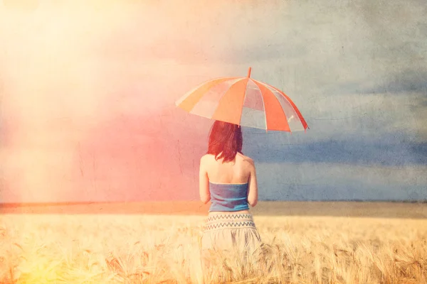 Redhead girl with umbrella at field — Stock Photo, Image