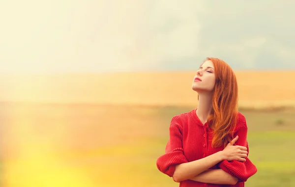 Redhead girl at meadow near wheat field — Stock Photo, Image