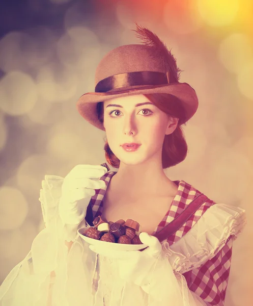 Beautiful redhead women with candy. — Stock Photo, Image