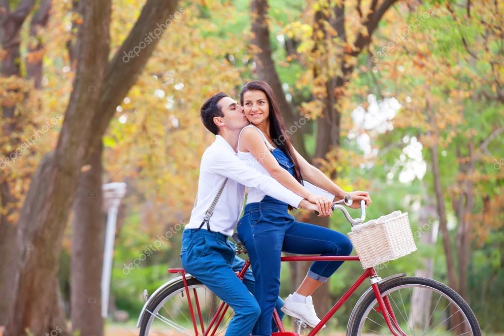 Teen couple with retro bike kissing in the park in autumn time Stock ...