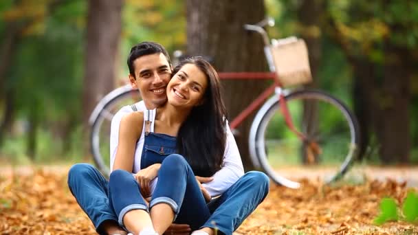 Adolescente casal com bicicleta retro beijando no parque no outono — Vídeo de Stock