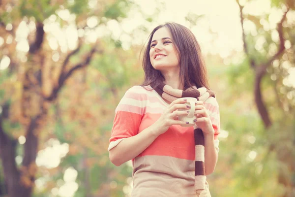 Belle fille brune avec tasse dans le parc. — Photo