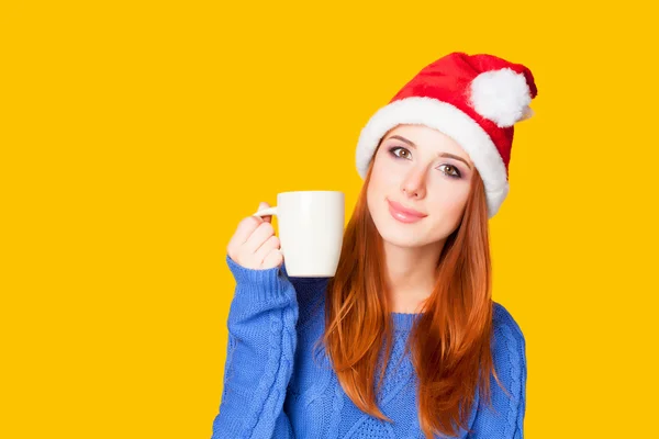 Redhead girl with cup on yellow background. — Stock Photo, Image