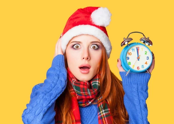 Redhead girl with alarm clock on yellow background. — Stock Photo, Image