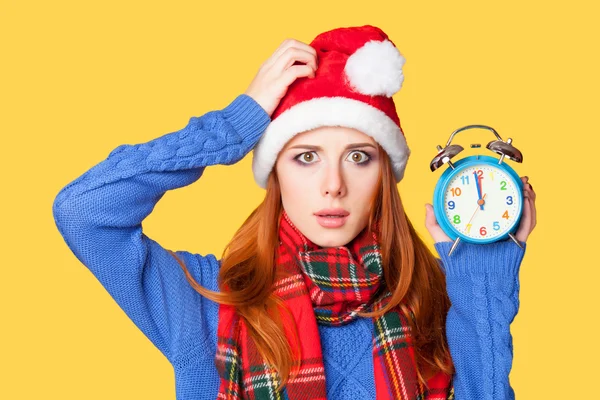 Redhead girl with alarm clock on yellow background. — Stock Photo, Image