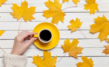 Kahve ahşap masa üzerinde tutan eller.