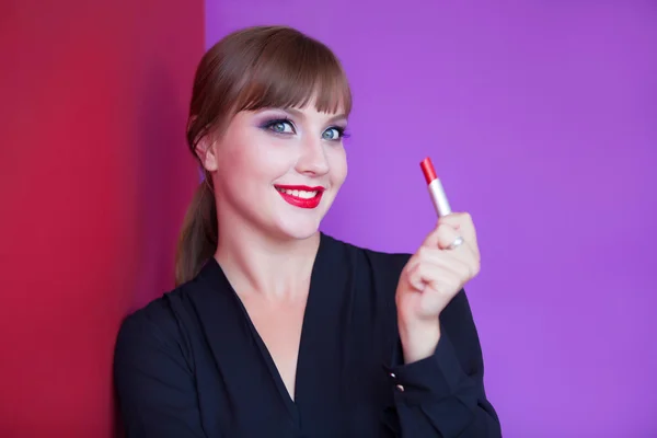 Brunette girl holding lipstick — Stock Photo, Image