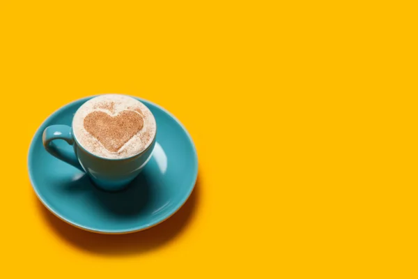 Cup of coffee with heart shape symbol on color background. — Stock Photo, Image
