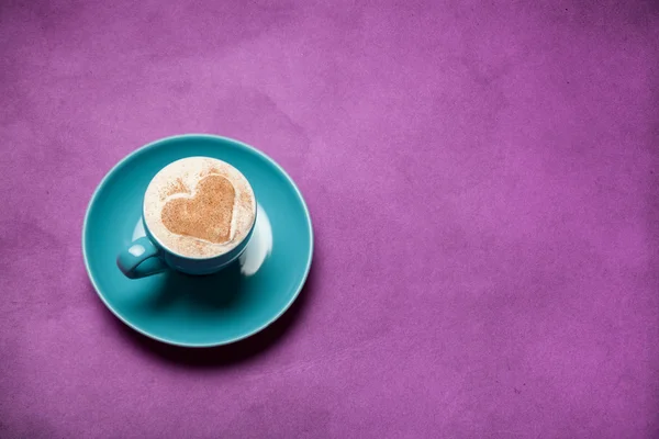 Cup of coffee with heart shape symbol on color background. — Stock Photo, Image