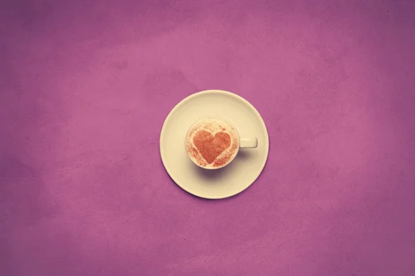 Cup of coffee with heart shape symbol on color background. — Stock Photo, Image