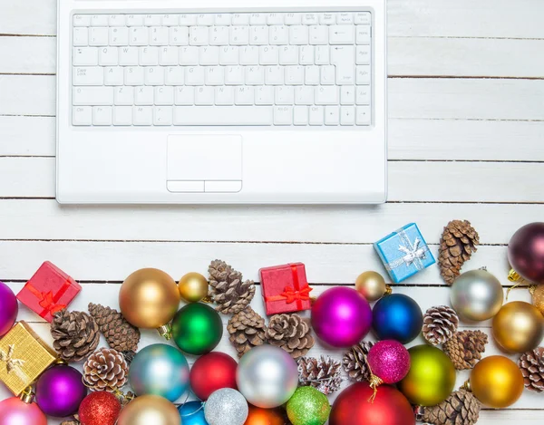 White laptop and christmas toys. — Stock Photo, Image