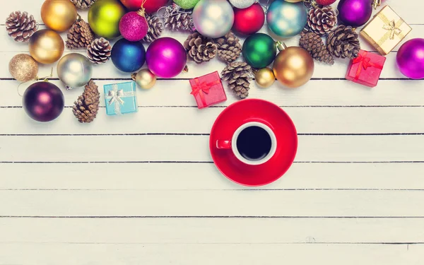 Filiżankę kawy i Boże Narodzenie zabawki na stół biały. — Zdjęcie stockowe