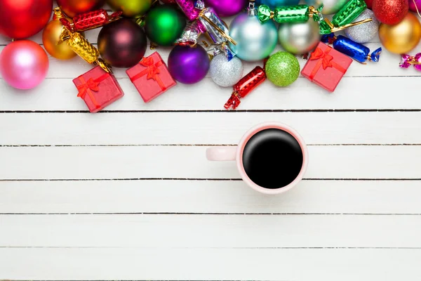 Coffee cup and christmas toys on white background. — Stock Photo, Image