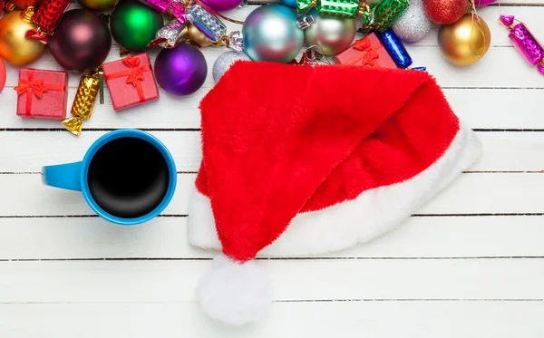 Cup of coffee and christmas toys on white table. — Stock Photo, Image