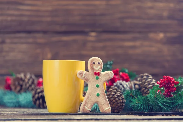 Gingerbread man near cup and Pine branch — Stock Photo, Image