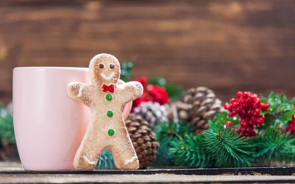 Gingerbread man near cup and Pine branch — Stock Photo, Image