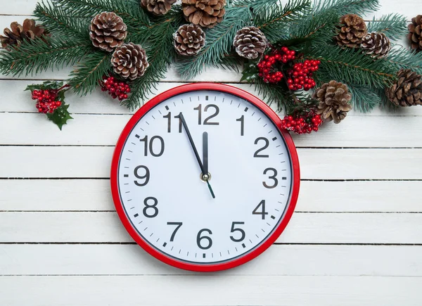 Alarm clock near Pine branches on wooden table. — Stock Photo, Image