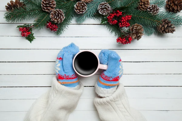 Girl holding cup of coffee near Pine branches — Stock Photo, Image