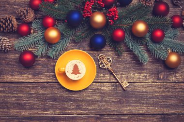 Noel ağacı şeklinde ahşap bir masa üzerinde sıcak cappuccino 